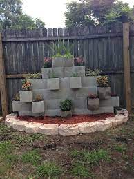 Community answer when building the footing, cut a 2 x 4 on an angle along both sides so as to make a v shape, so the top of the 2x4 is 3.5 and the bottom is about 1.5. Cinder Block Garden Wall Our Newest Addition To The Backyard Cinder Block Garden Concrete Garden Cinder Block Garden Wall