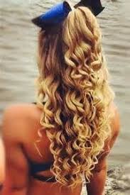 Portrait of a beautiful woman with long curly brown hair. Cute Cheer Hair Half Up Hair Styles Long Hair Styles Hair