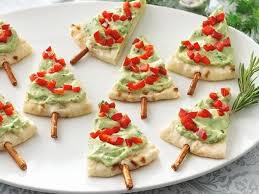Its colorful appearance makes a stunning addition to any buffet. Serve Guacamole The Festive Way With Pita Bread And Pretzel Sticks Healthy Christmas Treats Healthy Christmas Recipes Christmas Food