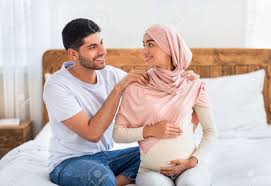 Pregnancy Body Massage. Caring Muslim Husband Massaging Shoulders Of His  Young Happy Pregnant Wife Stock Photo, Picture and Royalty Free Image.  Image 173540837.