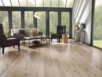 Bedroom interior with white and wooden walls, master bed standing on round carpet and wooden floor. 100 Wood Flooring Design Ideas Interior Design Design Flooring