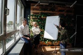 business people working with flip chart in green office