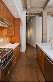 Brown kitchen offers white appliances and wooden cabinetry matching with the breakfast island that blends in with the hardwood flooring. 27 Brown Kitchen Cabinet Ideas Sebring Design Build