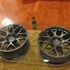 It features a wooden top with a rich, finish plus stationary metal wheels. 1