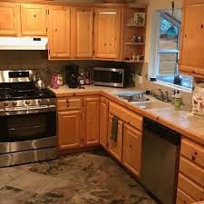 We also added bead board and mullioned glass doors for charm, used an inset doorstyle on the cabinets for authenticity, and mixed stone and wood counters to create an eclectic nuance in the space. Knotty Pine Kitchen Cabinets