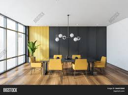 Minimal, modern dining room in interior with a table and contrasting white and yellow chairs around it white wall minimalistic scandinavian style dining room interior with a concrete floor, a round table and four. Gray Yellow Dining Image Photo Free Trial Bigstock