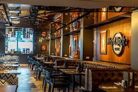 The Cafe S Layout Is Full Of Surfaces And Wood Accents And Natural Rock And Was Influenced By The Settings That Are Na Hard Rock Cafe Hard Rock Studio Interior