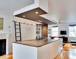 .oak sliding ladder, built in soft close drawers, storage cabinets, display cabinets with lighting, seating and all cabinetry has a sprayed finish and the sliding oak ladder is finished in a natural oil. Library Ladder Kitchens