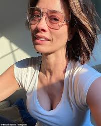 Melanie Sykes, 49, shows off her washboard abs in a crop top