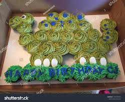 Dinosaur Shaped Cupcake Cake Dinosaur Themed Birthday Party Dinosaur Birthday Cakes Dinosaur Birthday Party