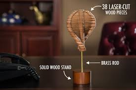 Boston university alum david roy has a passion for kinetic sculptures; Helicone Desk Toy Transforms From Helix To Pine Cone
