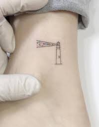 The lighthouse tattoo on the upper left arm with a dark color will camouflage with the light kin body to give swagger look. Small Lighthouse Tattoo On The Ankle