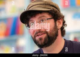 Childrens author Andy Stanton signing his book "Natboff! One Million Years  of Stupidity" for kids Hay Festival bookstore Hay-on-Wye UK KATHY DEWITT  Stock Photo