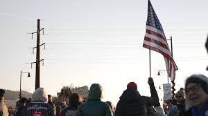 More than a thousand protesters line Beartracks Bridge for 'ICE Out' Rally