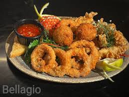 Delicious Bellagio appetizer mix Arancini, calamari and onion rings served  with sweet chili sauce♥️♥️.