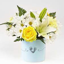Blooming with warmth and sunlight, this gorgeous flower bouquet brings together yellow roses, yellow carnations, yellow mini carnations, white asiatic lilies. Ftd Tiny Miracle New Baby Boy Bouquet Newborn Baby Flowers