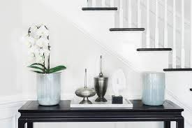 Crafted from solid and manufactured wood, it sports a solid finish that contrasts with a wood grain. Under Staircase Console Table Design Ideas