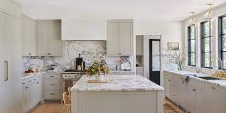 This elegant white and gray kitchen showcases modern design, from the decorative tile backsplash that runs from the marble countertops to the ceiling. 11 Gorgeous Marble Backsplashes That Ll Refresh Any Kitchen Martha Stewart