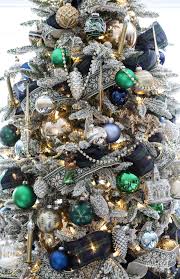 The frosty combination of silver and iced blue give a magical snow globe feel to this holidaydécor. Navy And Green Christmas Tree Christmas Tree Decor Ideas