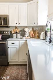 The light gray cabinetry contrasts well with the white island, marble countertops and subway tile. Gray And White Holiday Kitchen With Pops Of Pink House By Hoff
