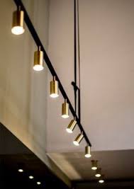 Brass Cylinder Lights On Black Track Retail Lighting Lighting Inspiration Interior Lighting