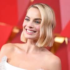 Margot Robbie wells up when her brother surprises her in an interview