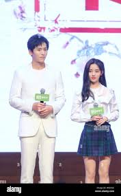 Chinese singer and actress Ju Jingyi, right, and actor Zhang Zhehan attend  a fan meeting to promote their new TV drama Legend of Yunxi in Beijing, C  Stock Photo - Alamy