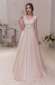 Bride in pink wedding dress walking to the beach. Blush Bridal Dresses Pale Pink Wedding Gowns June Bridals