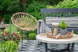 Here, a distinctive dining set combines glitzy chairs with a table crafted from a carved base and a glass top. Sophisticated Bohemian Outdoor Setting Hallstrom Home Boho Outdoor Space Bohemian Outdoor Boho Patio