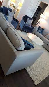 Contemporary Gray Linen Couches Paired With Blue Velvet Accent Chairs Make For A Visually Pleasing Blue Accents Living Room Living Room Grey Blue Accent Chairs