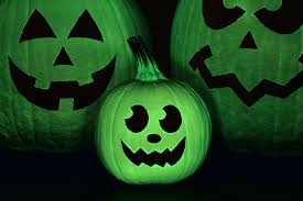 Halloween ghost scary purple background. Glow In The Dark Pumpkins