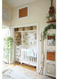 A chic space with a glam feel and a crib by the window, a giraffe toy and a rug are matching. Sharing Master Bedroom With Baby Nursery Design Studio
