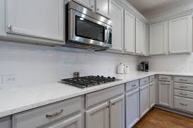 Refinished Cabinets In A Light Gray With New Silver Hardware Quartz Countertops Stainless Steel Appliances And Kitchen Design Refinishing Cabinets Countertops