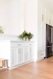Your shaker cabinet hardware will consist of cabinet knobs and pulls, most likely a mix of both. Black Refrigerator Surrounded With White Shaker Cabinets Transitional Kitchen