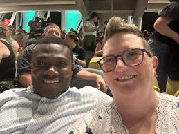 Can someone edit our photo to fix eyes, background, and arm appearance?