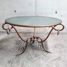 The design is contemporary, and the translucent top shows off the ironwork to best advantage. Wrought Iron Coffee Table By Rene Drouet 1940s 117410