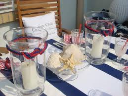 A tropical beach wedding centerpiece with a mirror, a starfish, candles and peachy callas. Sea Inspired Table Setting And Ideas For Your Beach Themed Party