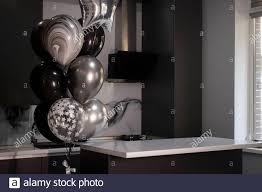 Chemical substance and countertop · see more » countrywide legal indemnities Corner Of Stylish Minimalistic Grey Kitchen Dark Gray Cupboards White Countertops And Bar With Stools Black Sink Kettle And Stove And Black And W Stock Photo Alamy