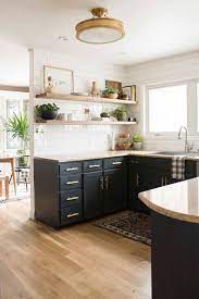 In a kitchen with black cabinets the lighting is as important as the color choices to maintain a balance between the dark of the cabinets and the light of the room. Pin By Skyler Niewiadomski On Mid Century Modern Theme Kitchen Design