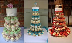 A gently arranged bunch of cupcakes set on top of wooden tiered platters are a gorgeous edible addition to any outdoor wedding venue. Heaven Is A Cupcake Wedding Cakes In Hertfordshire