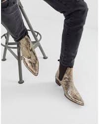 Harry styles is a fashion icon, and if he has one signature outfit staple, it would definitely be his heeled boots.but there's more to this very british choice than just looks. Harry Styles Wearing Black Vertical Striped Dress Shirt Black Skinny Jeans Gold Leather Chelsea Boots Lookastic