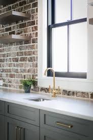 Brick walls in kitchens can be used as inspiration for your decorating scheme, no matter what interior design style you gravitate toward. Gray Pantry Cabinets With Exposed Brick Wall Cottage Kitchen