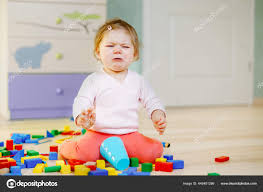 Upset Crying Baby Girl With Educational Toys Sad Tired Or Hungry Alone Healthy Child Sitting Near Colorful Different Wooden Blocks At Home Or Nursery Baby Missing Mother In Daycare Stock Photo By C