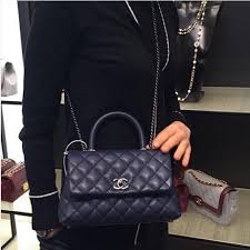 Chanel bags are effortlessly elegant, sophisticatedly polished, versatile, and chic enough to fit your season's uniform. Chanel Small Coco Handle Bag In Black Grained Calfskin With Black Handle Chanel Coco Handle Coco Handle Chanel Handbags