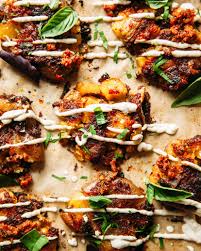 Smashed Sun Dried Tomato Pesto Potatoes With Caesar Drizzle Pesto Potatoes Healthy Food Blogs Tomato Recipes