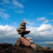 A small sandbox with five stones stacked in the middle. Stone Stacking Cool For Instagram Cruel For The Environment Patrick Barkham The Guardian