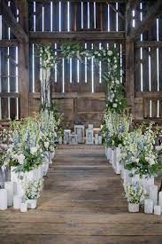 Rustic Wedding Decor White Flower Ceremony Aisle In The Barn Blynda Dacosta Photography Rustic Wedding Decor Wedding Aisle Decorations Blue Themed Wedding