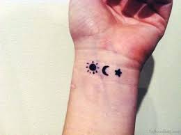 A crescent moon is accented by a pair of stars in this wrist tattoo. 46 Stunning Sun Tattoos On Wrist
