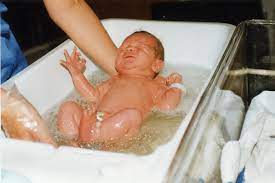 The front of the towel will fall away, but the back will stay between your arm. File Baby S First Bath Jpg Wikimedia Commons