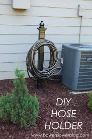 They can protect hoses from unnecessary weather damage and help prevent tripping hazards. Hosed Bower Power Diy Garden Hose Holder Garden Hose Holder Diy Garden Projects